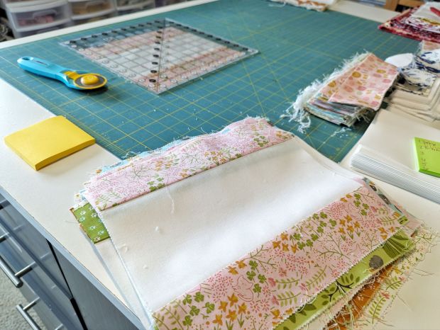 Jelly Bar Quilt blocks in-progress, made with pink and green cat fabrics