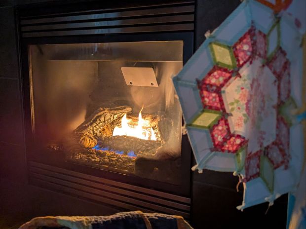 Smitten English-paper-pieced quilt illuminated by the glow of a fire during a power outage during a windstorm in Washington State