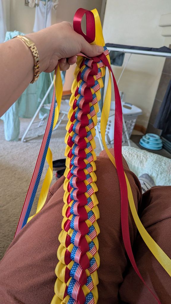 Graduation RIbbon Lei made with maroon, gold, and American Flag-print ribbons
