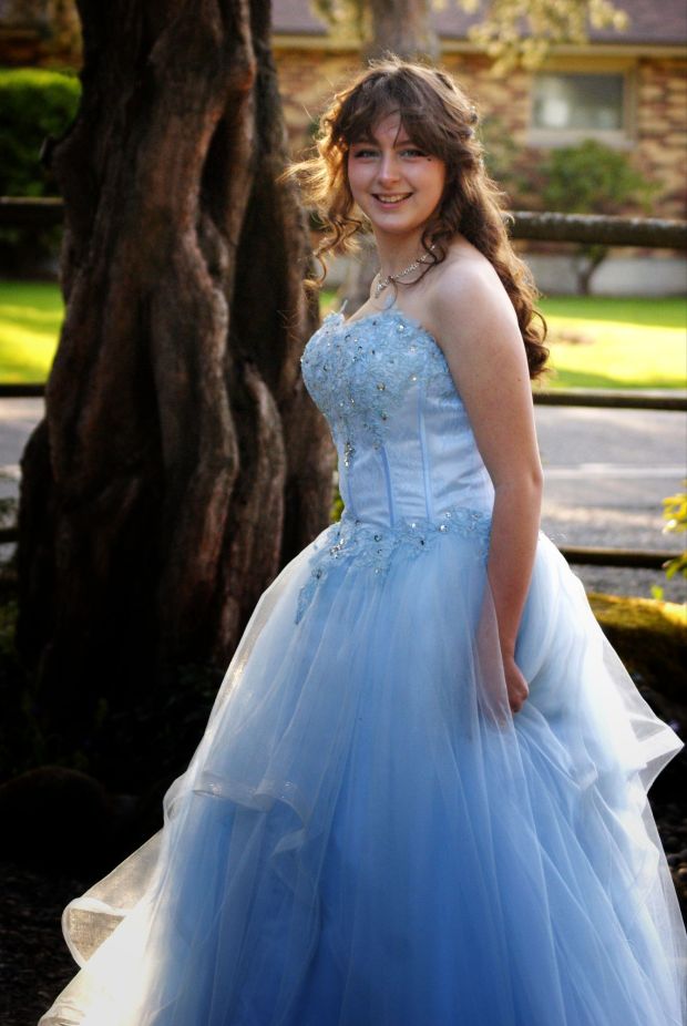 Teenaged girl in her Cinderella-blue strapless prom dress in 2025.