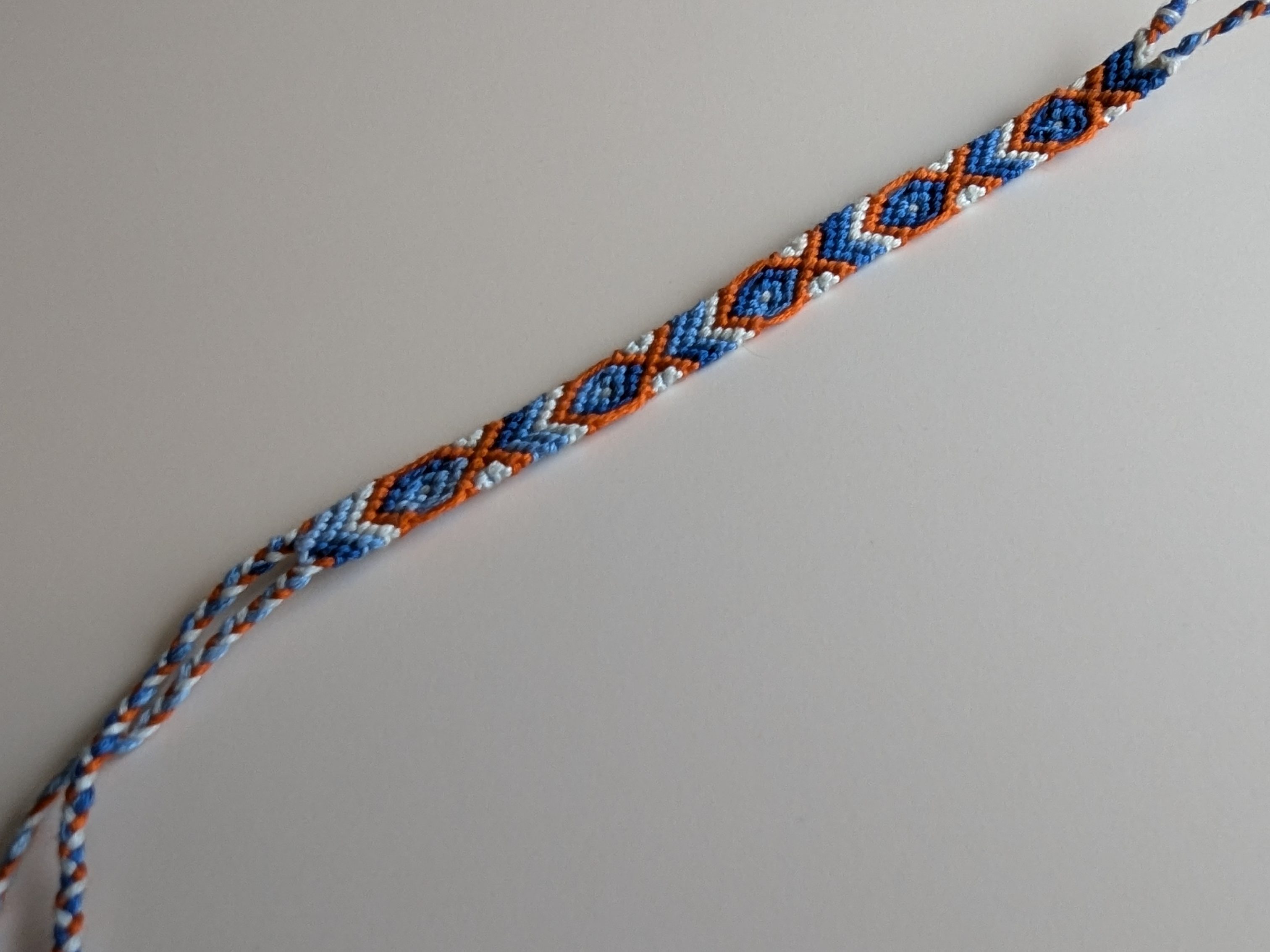 Fish Friendship Bracelet made with orange and blue embroidery floss