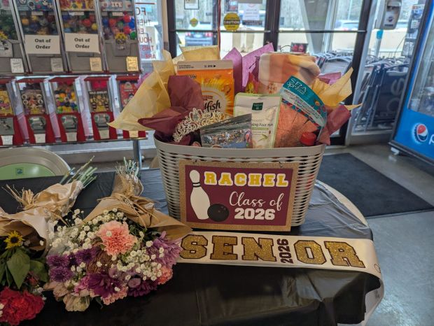 High school senior girl bowling senior night with personalized sash and gift basket in maroon and gold