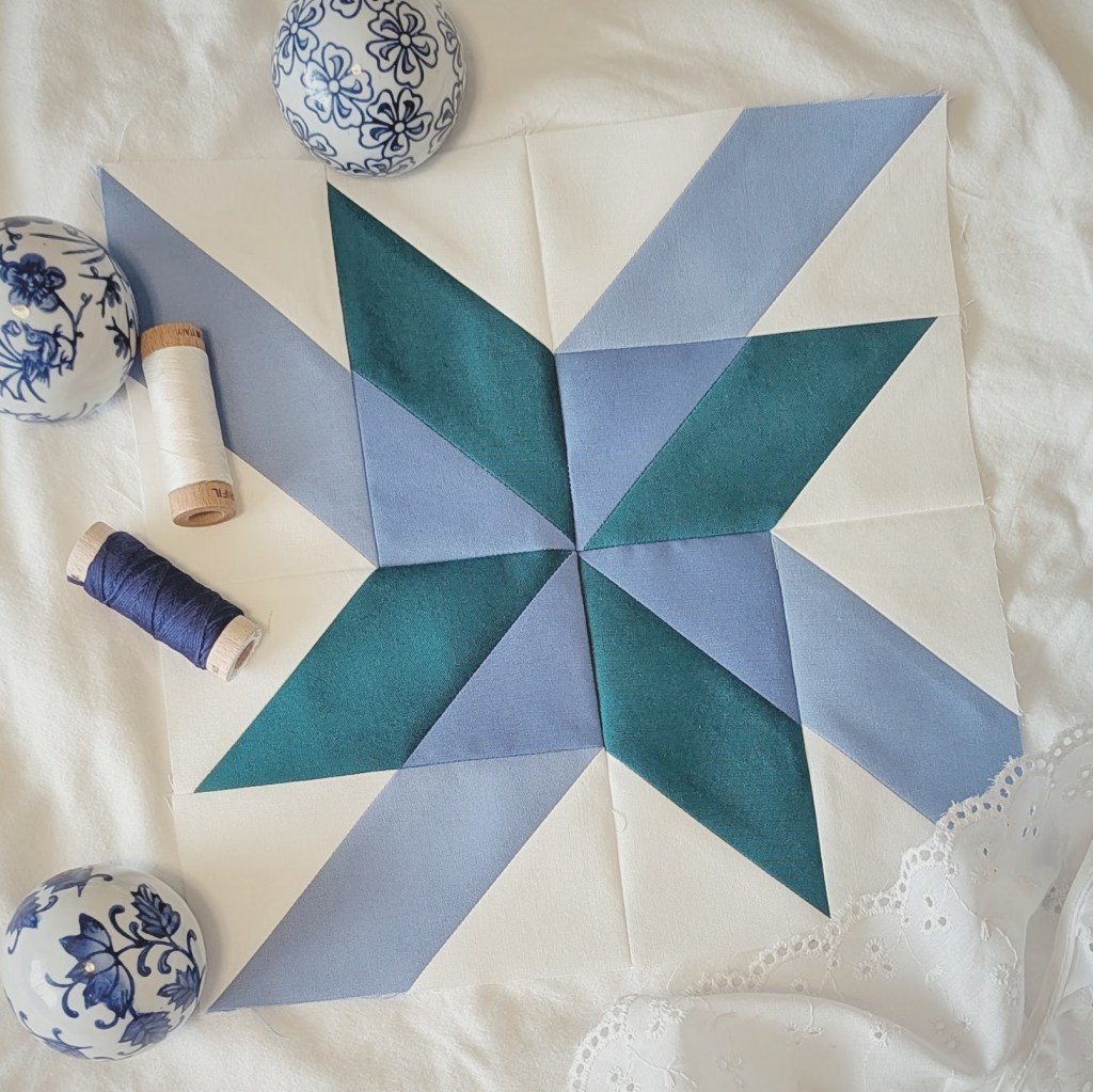 Block 2 “Spin Around” by Amy Smart in the RBD 2026 Block Challenge Sew Along sewn in blues, and green