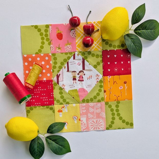 Sewcialites 3 Block #6 Window Seat made with green, red, orange, yellow and pink fabrics.