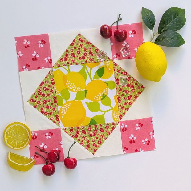 Block 11 "Snuggle Patch," in the Fat Quarter Shop Sewcialites 3 Sew Along, designed by Edyta Sitar and sewn up in yellow, green and pink.