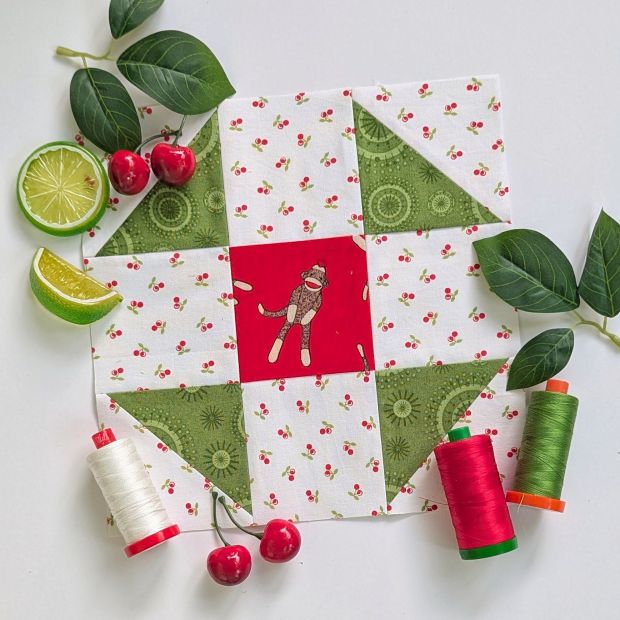 Block 12 "Shoo Fly" designed by Sharon Holland, for the Fat Quarter Shop Sewcialites 3 Sew Along and sewn up in red and green.