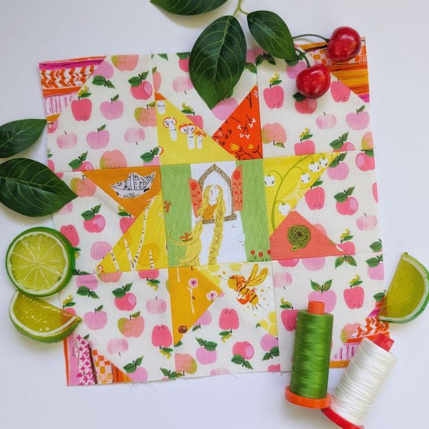Block 14 "Criss-Cross Star," designed by Lori Holt for Fat Quarter Shop's Sewcialites 3 sew along, sewn up in Heather Ross fabrics in pink, orange, yellow and green.