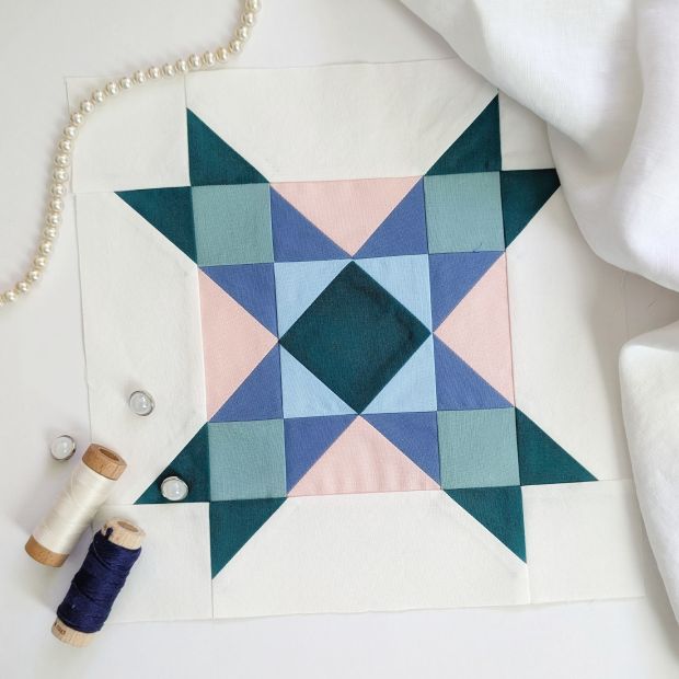 Block 15 in the 2026 Riley Blake Designs Block Challenge "Center of Attention" designed by Heather Peterson, sewn up in Confetti Cottons solids in green, blues and pinks.