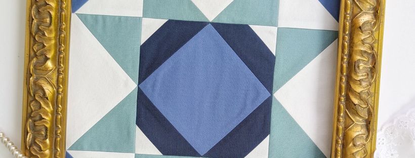 Block 16 "Kaleidoscope Star," designed by Tara Reed for the Riley Blake Designs Block Challenge 2026 sew along in shades of green and blue.
