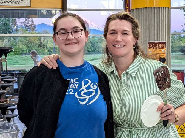 Cara and Renaissance Brooke serving cake at the end of year band concert