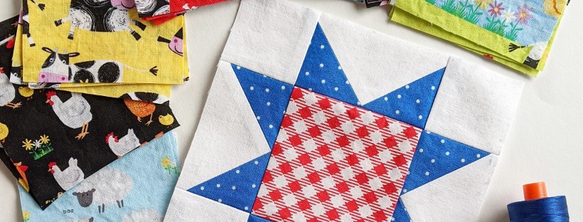 A red, white, and blue sawtooth star quilt block with farm animal fabric squares