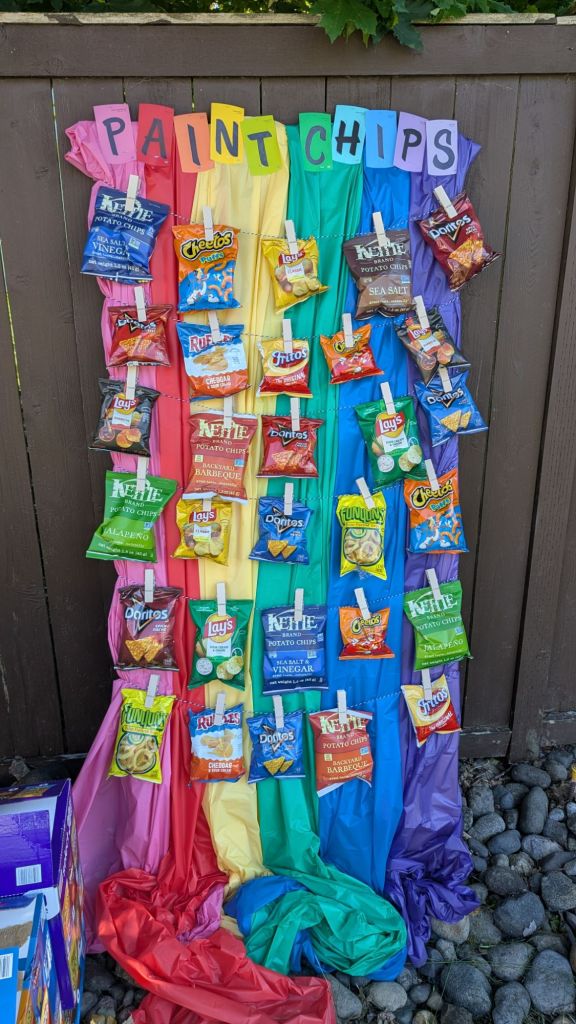Rainbow paint chips board with bags of chips attached