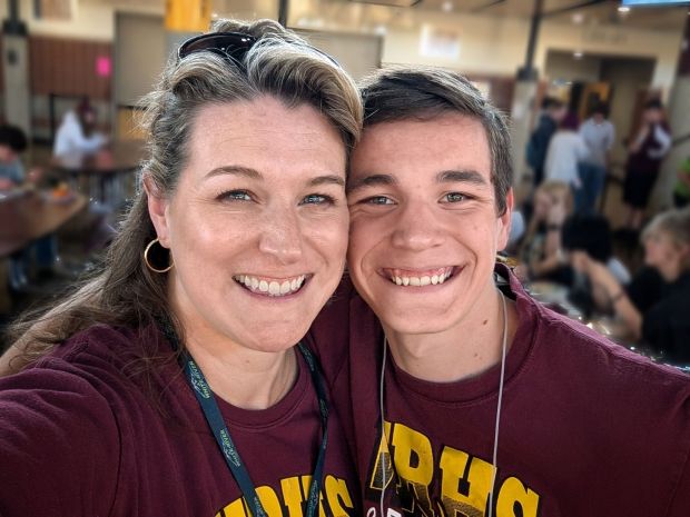 Mother and son hugging at a pep band pre-game potluck dinner