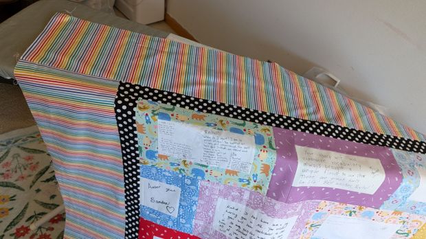Borders on the artist graduation quilt in black polka dot and rainbow stripes.